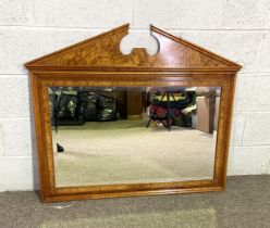 A large modern walnut veneered overmantel mirror with broken arch surmount and bevelled plate
