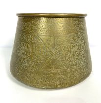 A large brass Islamic jardiniere, with repousse decorated sides, with roundels and borders