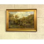 A. Maxwell, British, early 20th century, A wooded river landscape with a stone bridge, oil on