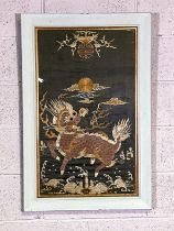 A Chinese silk and embroidered panel, decorated with a Qilin (A mythological beast), with sun above,