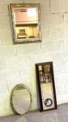 Three assorted modern mirrors, including a cushion framed mirror and flower head decorated oval