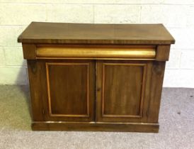 A small Victorian mahogany veneered side cabinet, with ogee moulded drawer and two cabinet doors