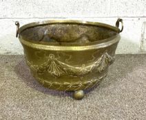 A large brass repousse log bin or jardinere, with swag decoration and two loop handles. Diameter 16"