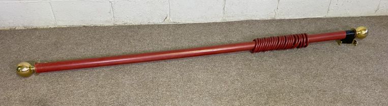 A vintage curtain pole with heavy brass finials and 12 rings, 230cm x 6cm diameter.