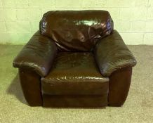 A modern dark tan leather armchair, with padded back and seat
