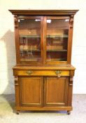 A Victorian mahogany bookcase, with two glazed doors, opening to three adjustable shelves, the