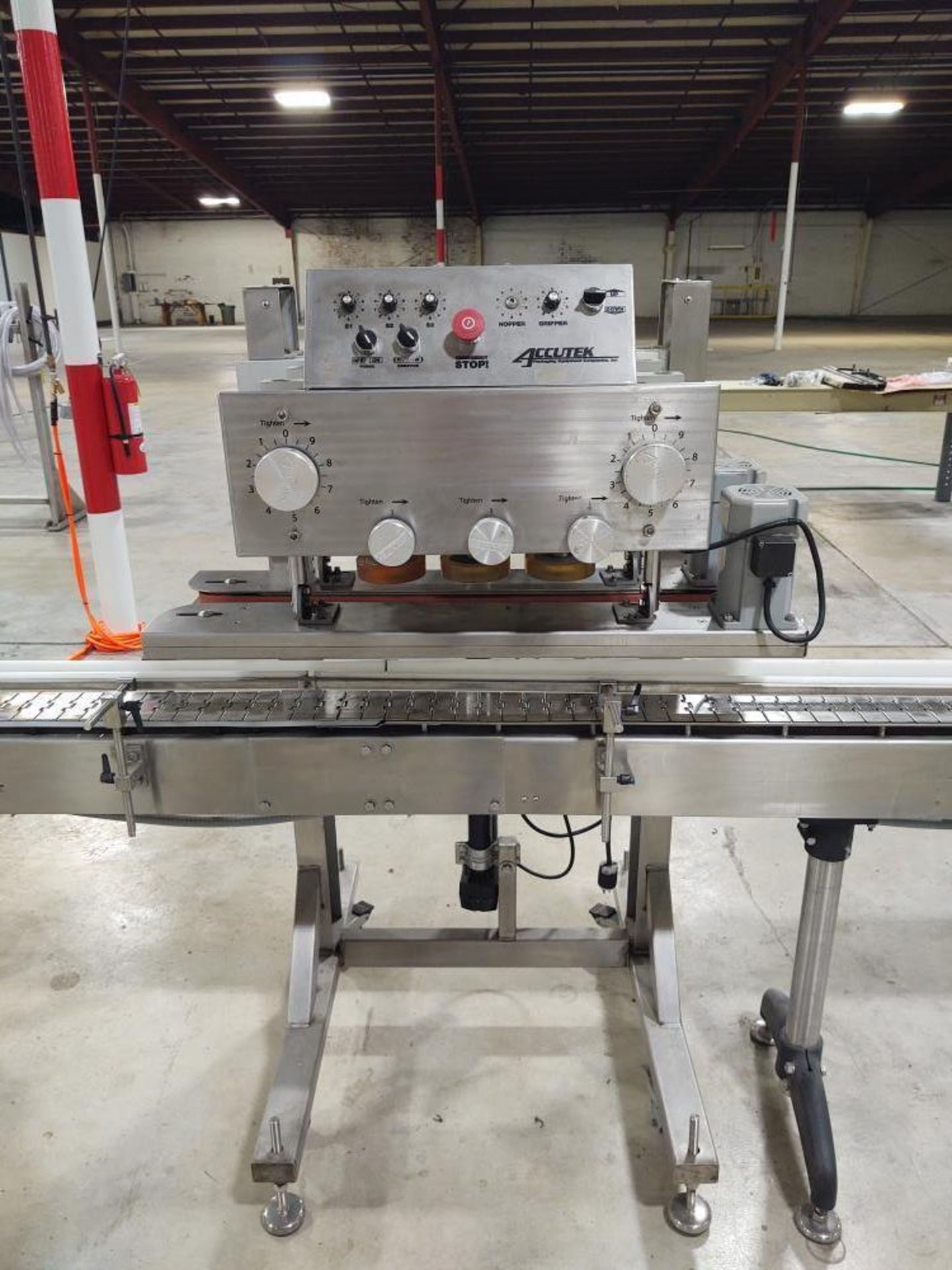 Used- Accutek In-Line Spindle Capper with 6-Spindles, Model 22-505-000. Includes centrifugal cap sor