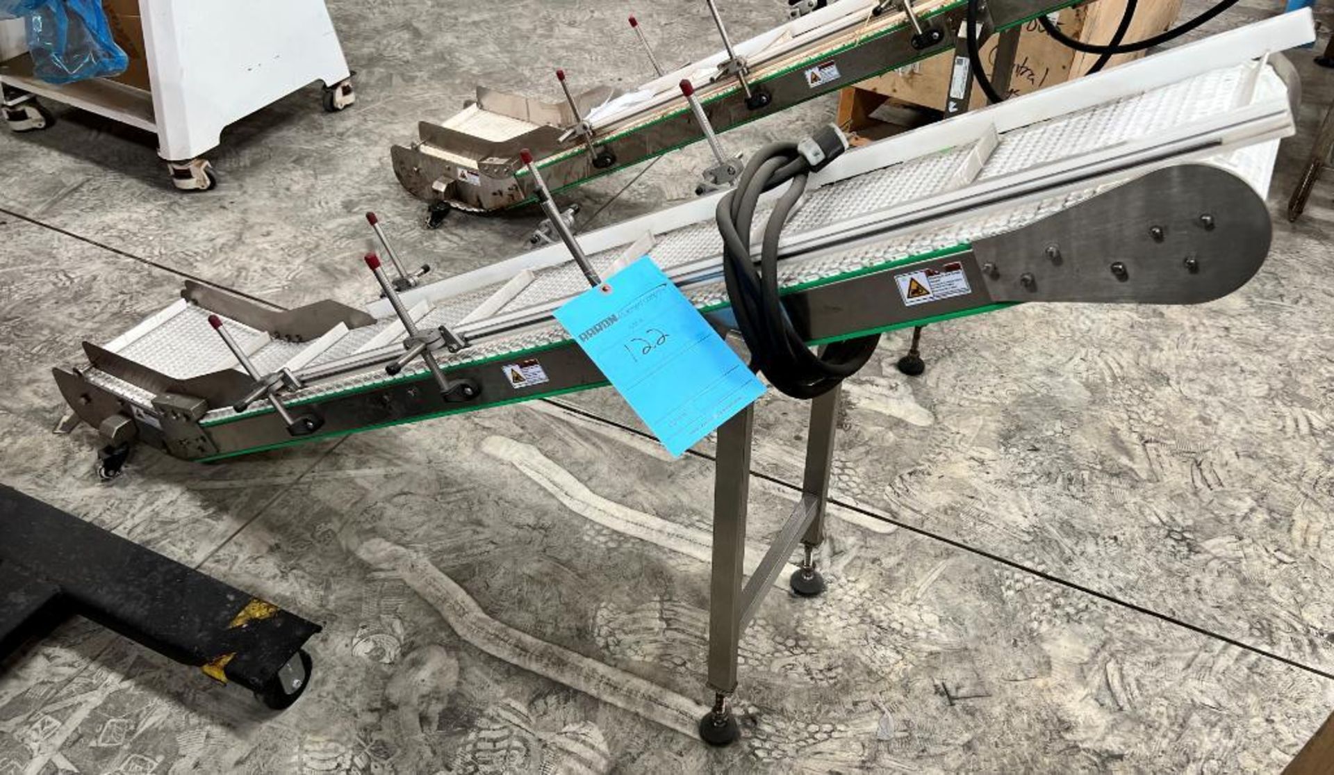 Inclined Plastic Belt Conveyor. Approximate 12" wide x 12" bottom infeed section x 72" inclined sect