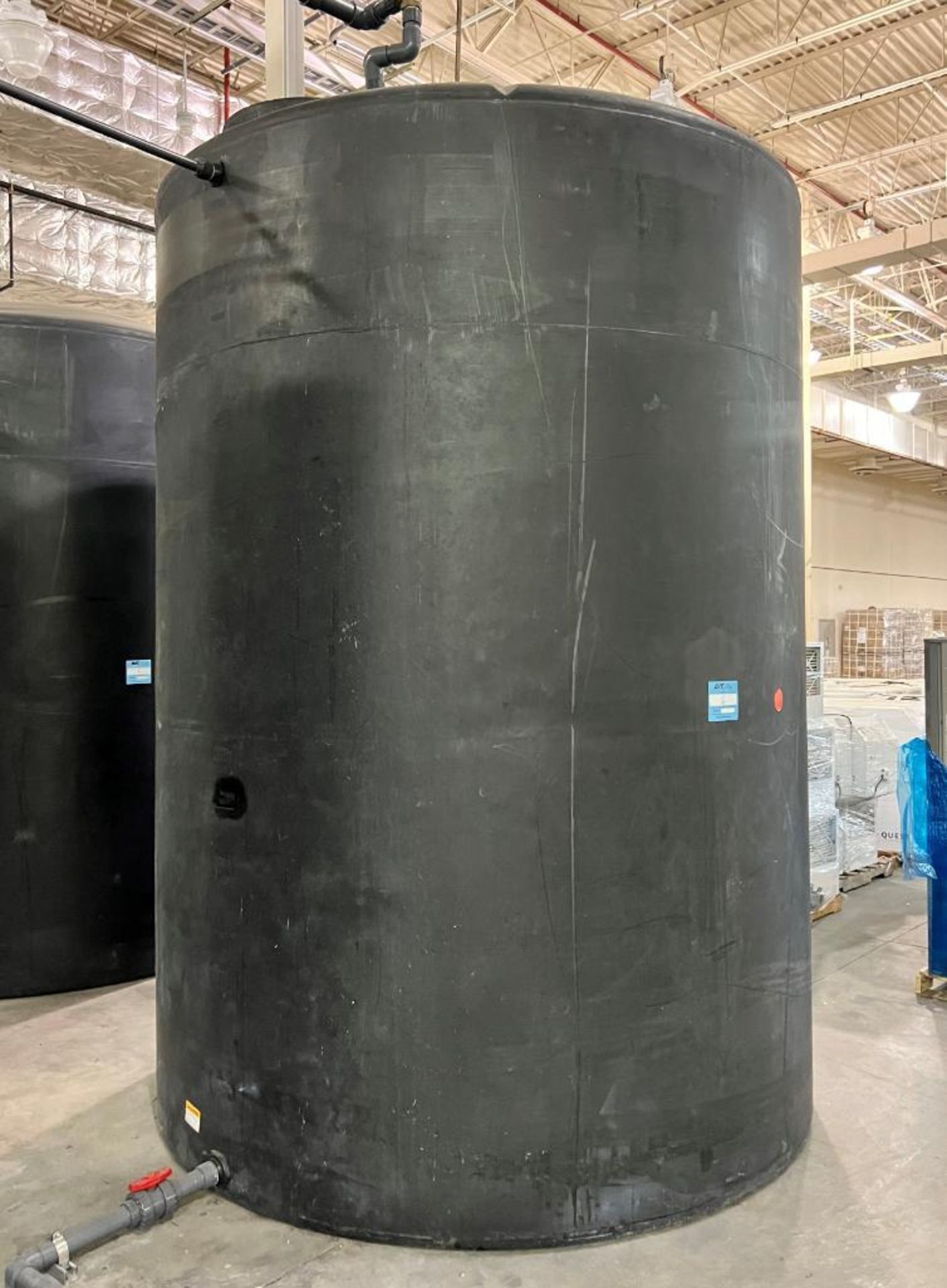 Approximate 4500 Gallon Black Poly Tank. Side bottom outlet.