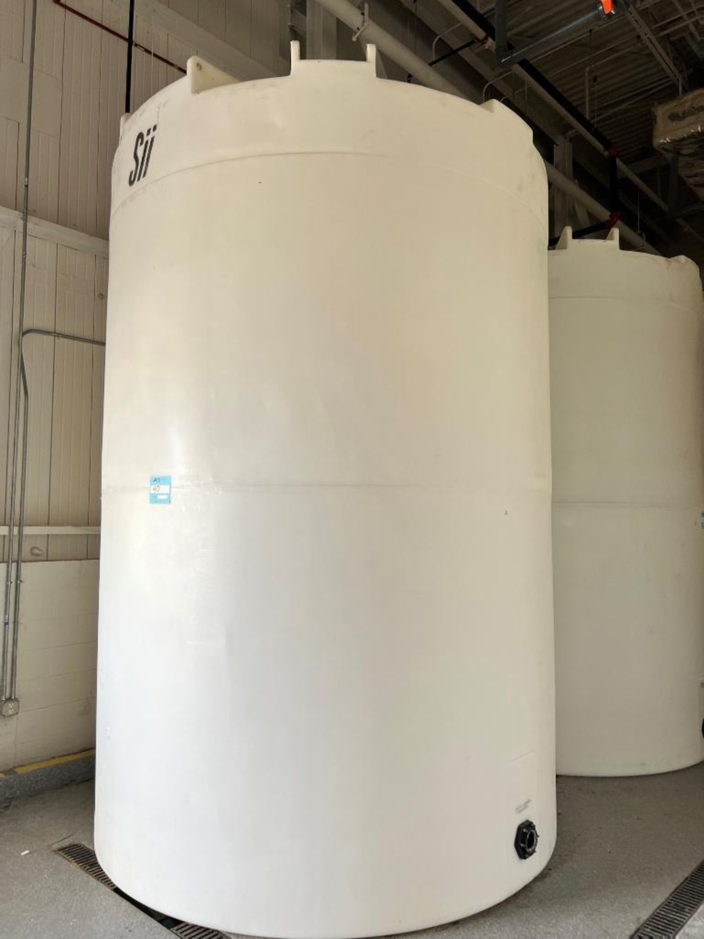 SII Approximate 5000 Gallon White Poly Tank. Side bottom outlet.