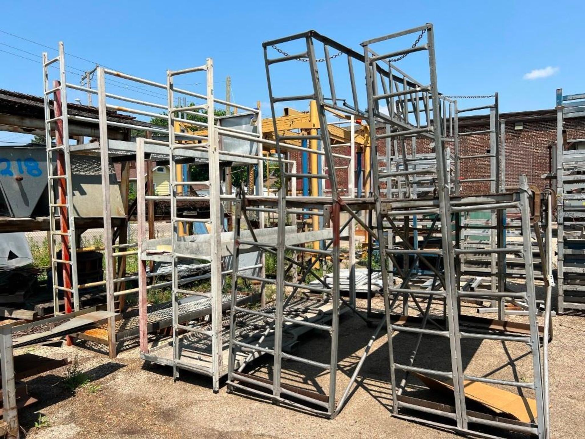 Contents of Rear Yard Including: Assorted Material Racks, Roller Conveyor, A-Frame Racks with Pipe &