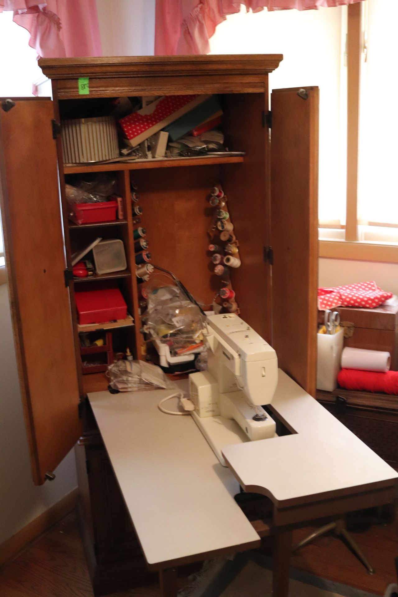 Bernina sewing machine, model 830, with hideaway cabinet and sewing supplies