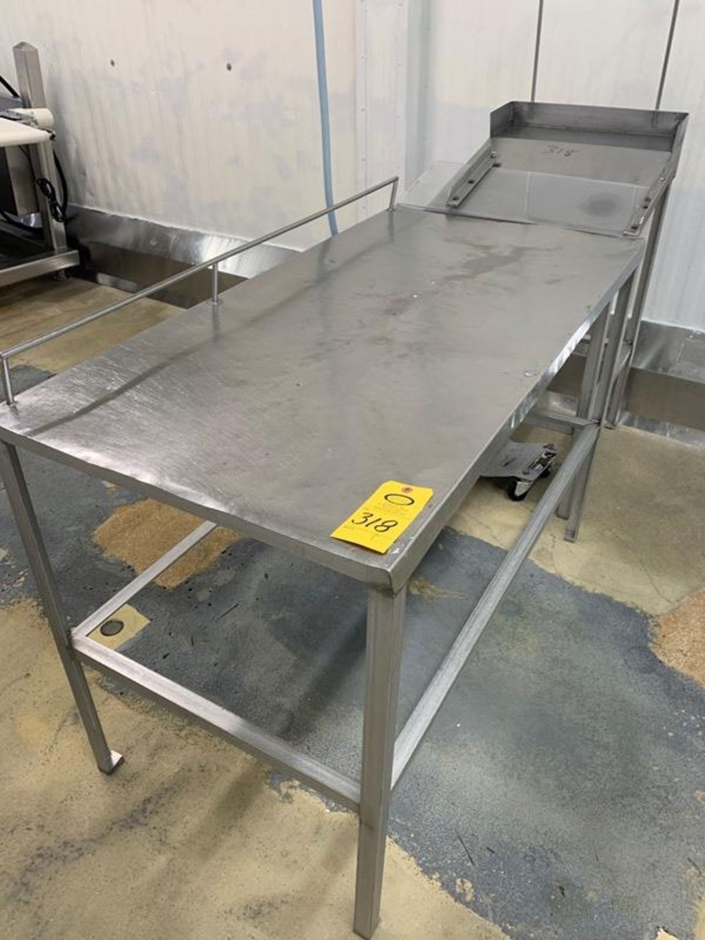 Lot Table (1) 30" W X 5' L X 36" H, (1) Foreman's Desk, (3) Stainless Steel Racks (Located in Mt.