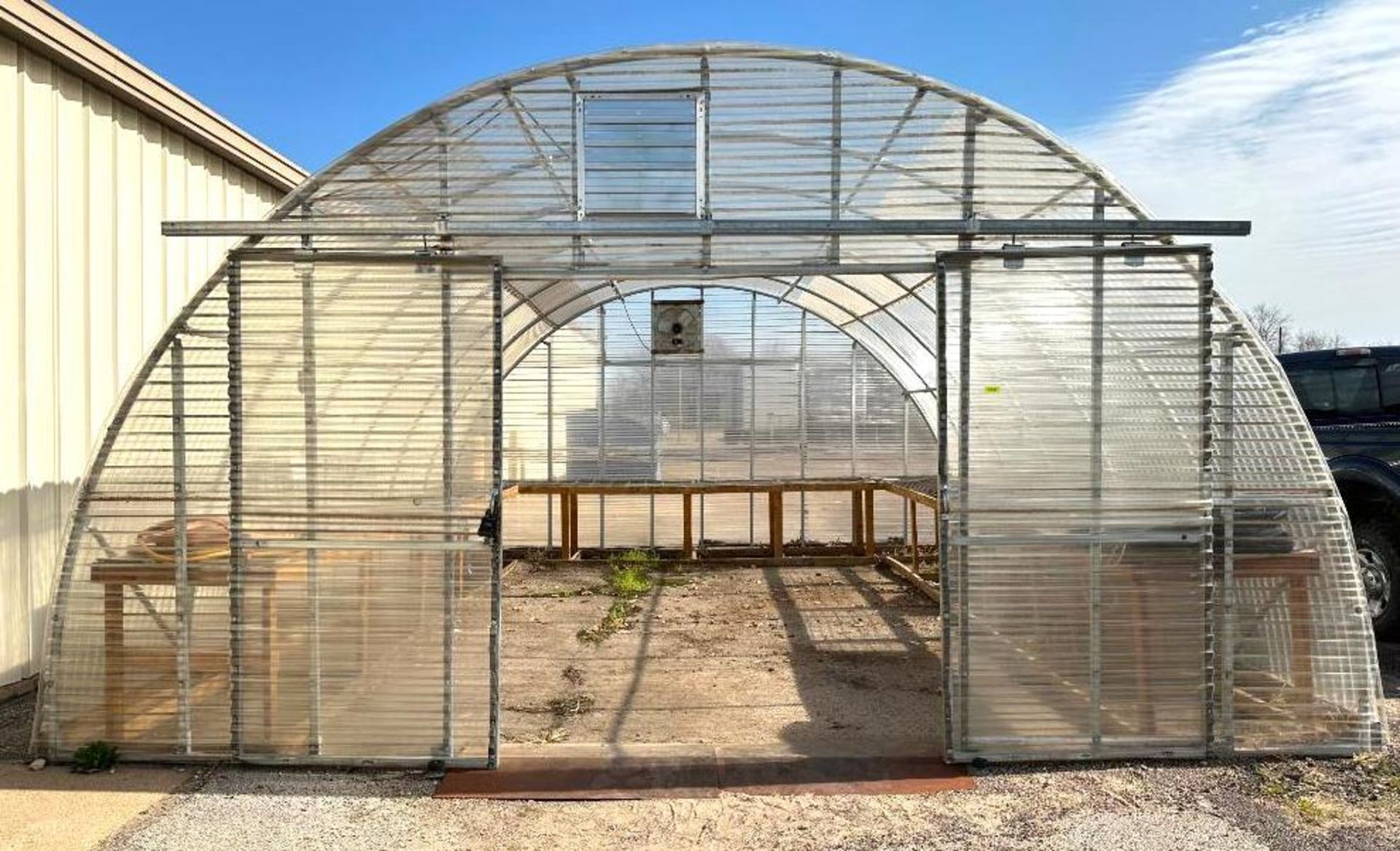 25' X 20' PLASTIC GREEN HOUSE W/ (2) EXHAUST FANS INFORMATION: WOODEN SHELF FRAMING SHOWN IN ADDITIO