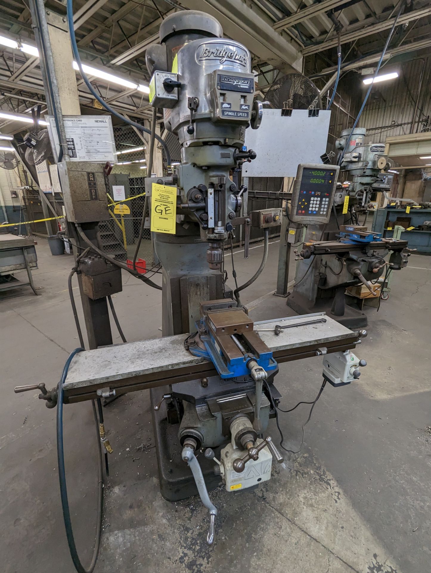 BRIDGEPORT VERTICAL MILLING MACHINE WITH KURT ANGLOCK VISE; LENGTH OF BED: 48"; DIGITAL READ OUT: