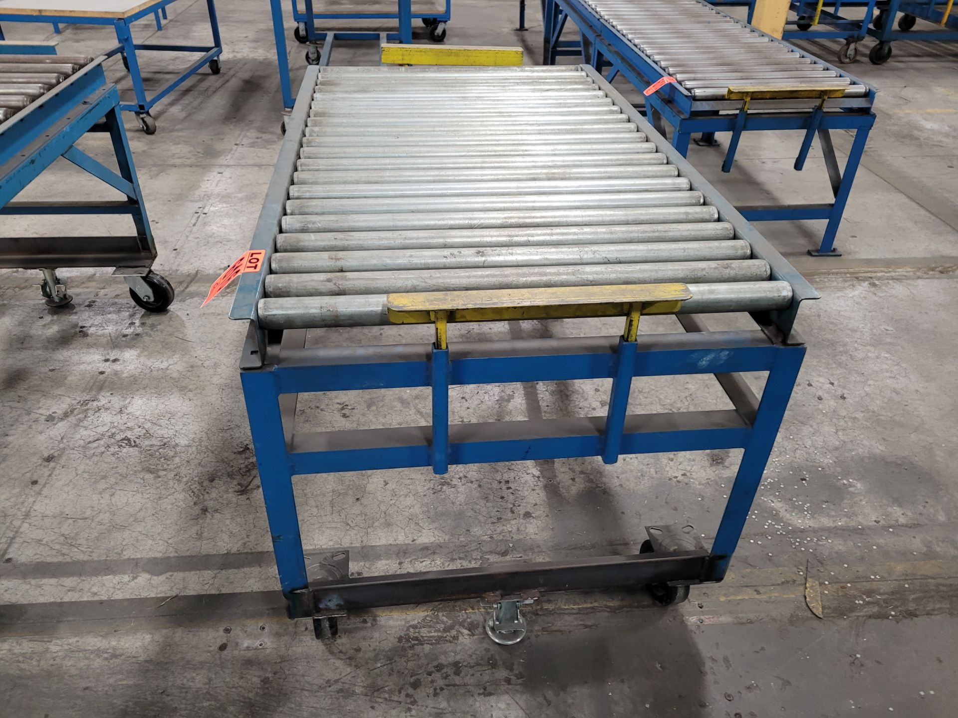 Mobile roller conveyor on casters w/floor lock and (2) adjustable steel backstops - Image 2 of 4