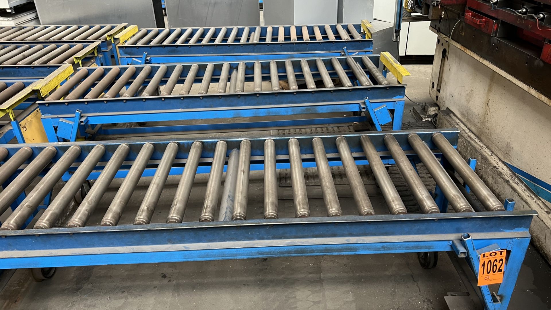Lot of (3) steel frame manual roller conveyors on rail wheels and casters w/ adj. bumper bars