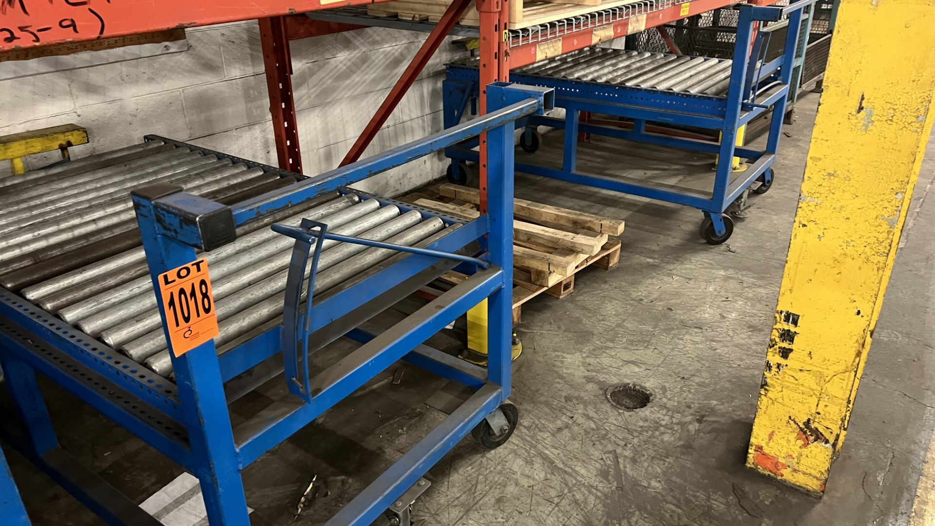 Lot of (2) steel frame manual roller conveyors w/ handles, casters, foot lock and adjustable height