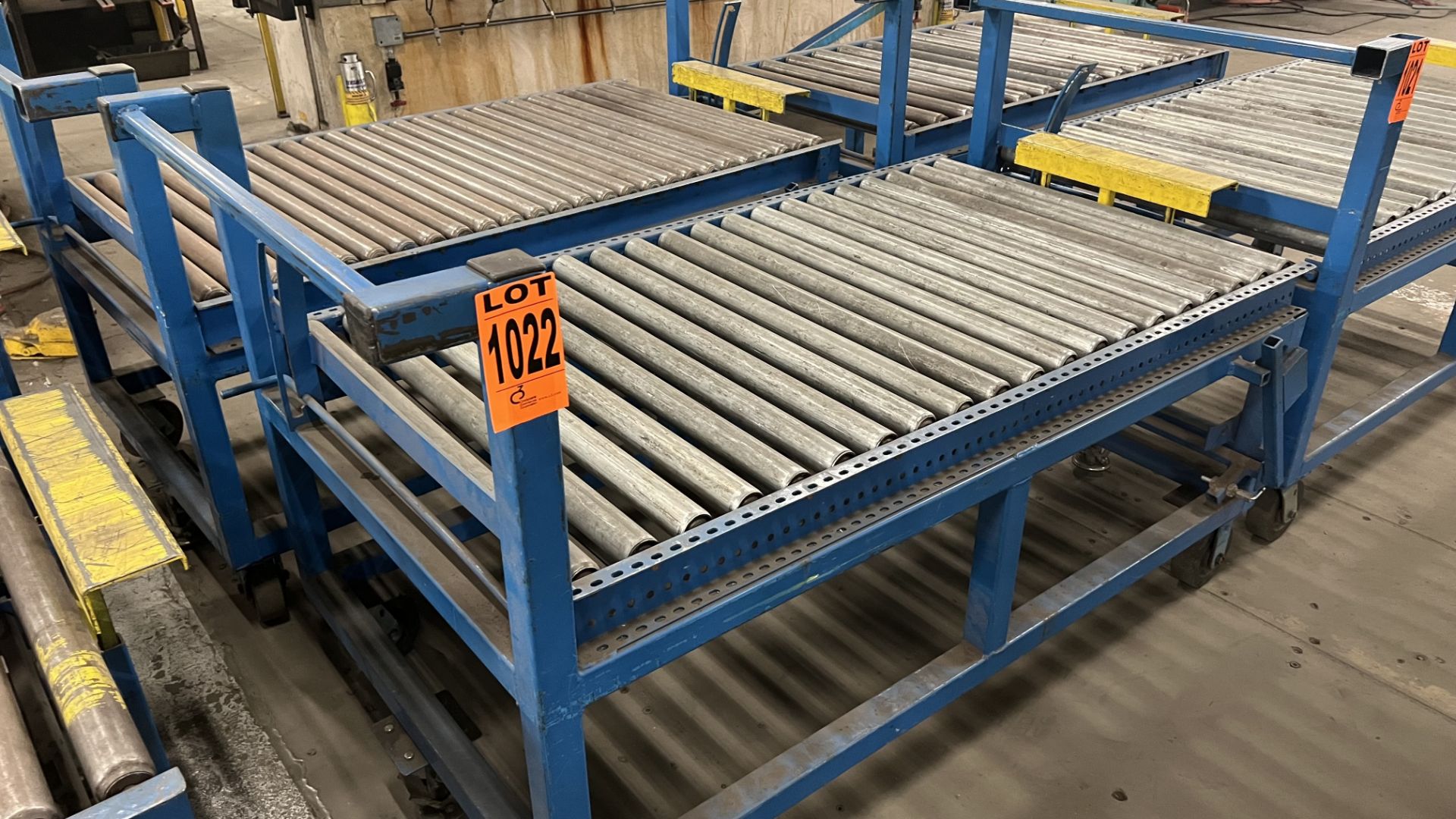 Lot of (2) steel frame manual roller conveyors w/ handles, casters, foot lock and adjustable height