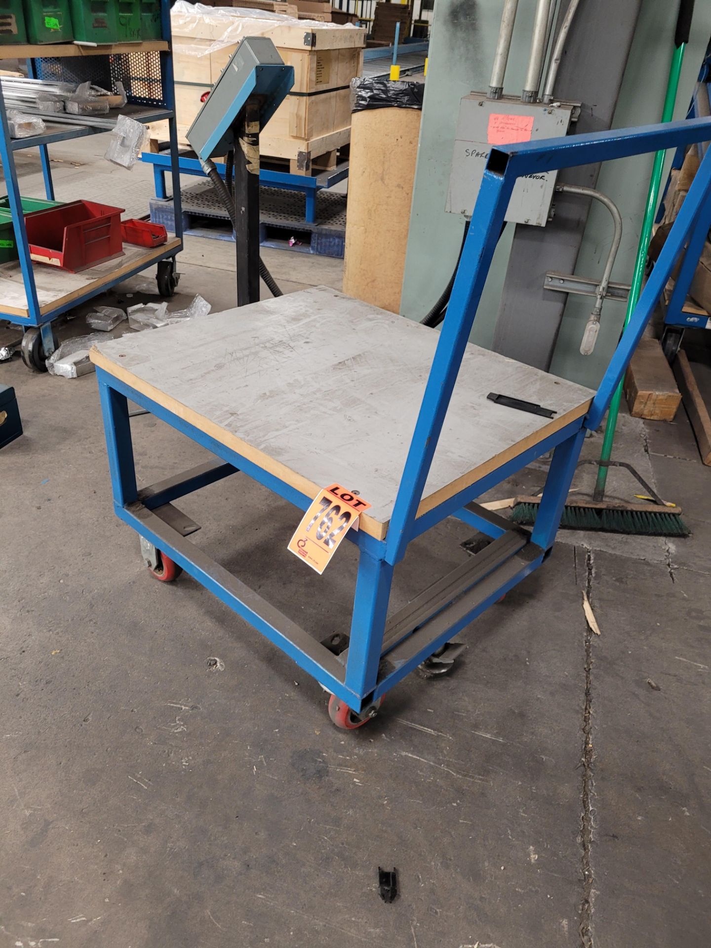 Steel frame platform cart w/ casters, floor lock, handle and plywood surface - Image 2 of 2