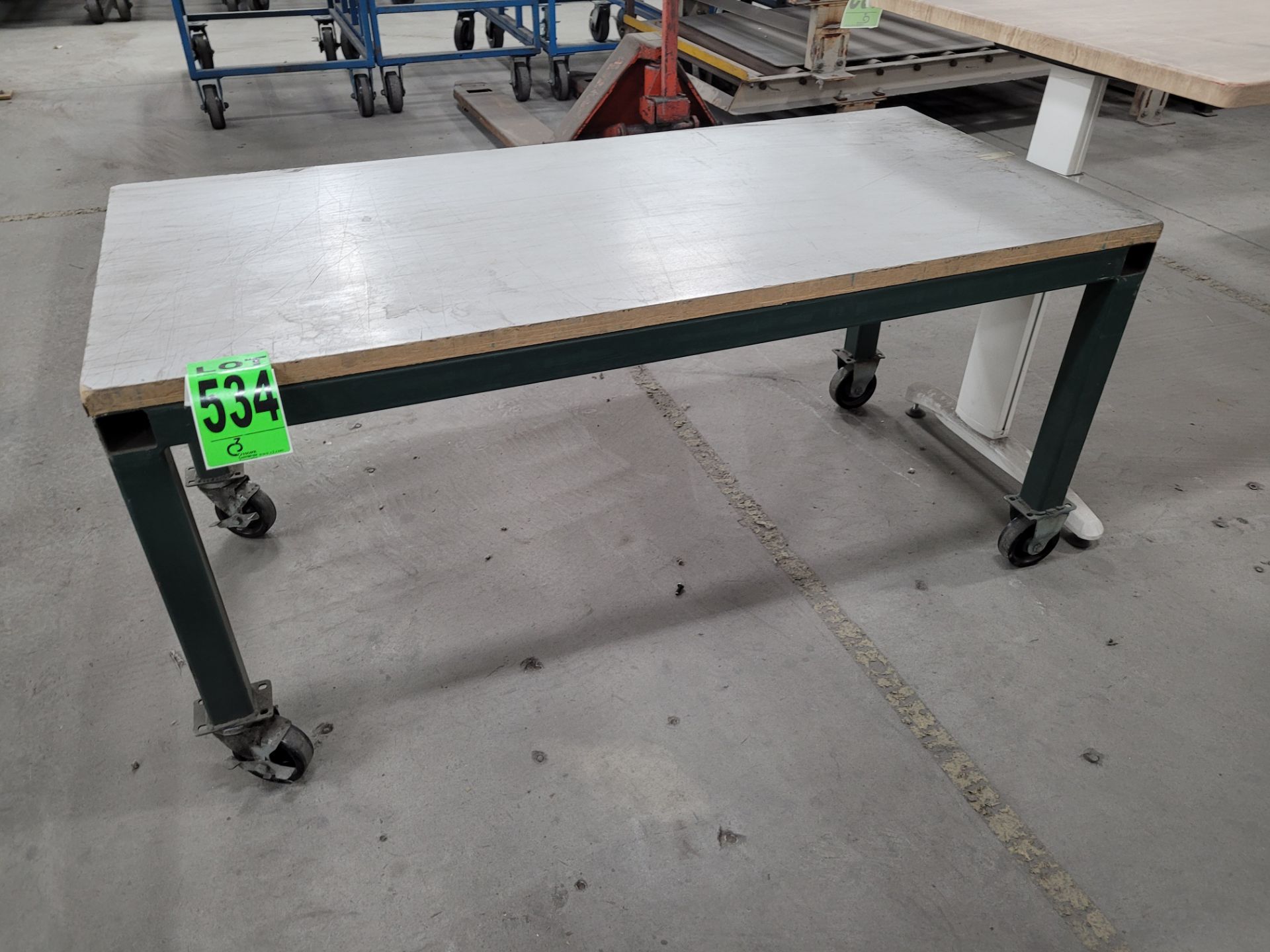 Steel frame mobile platform w/ 2" plywood surface, on lockable casters