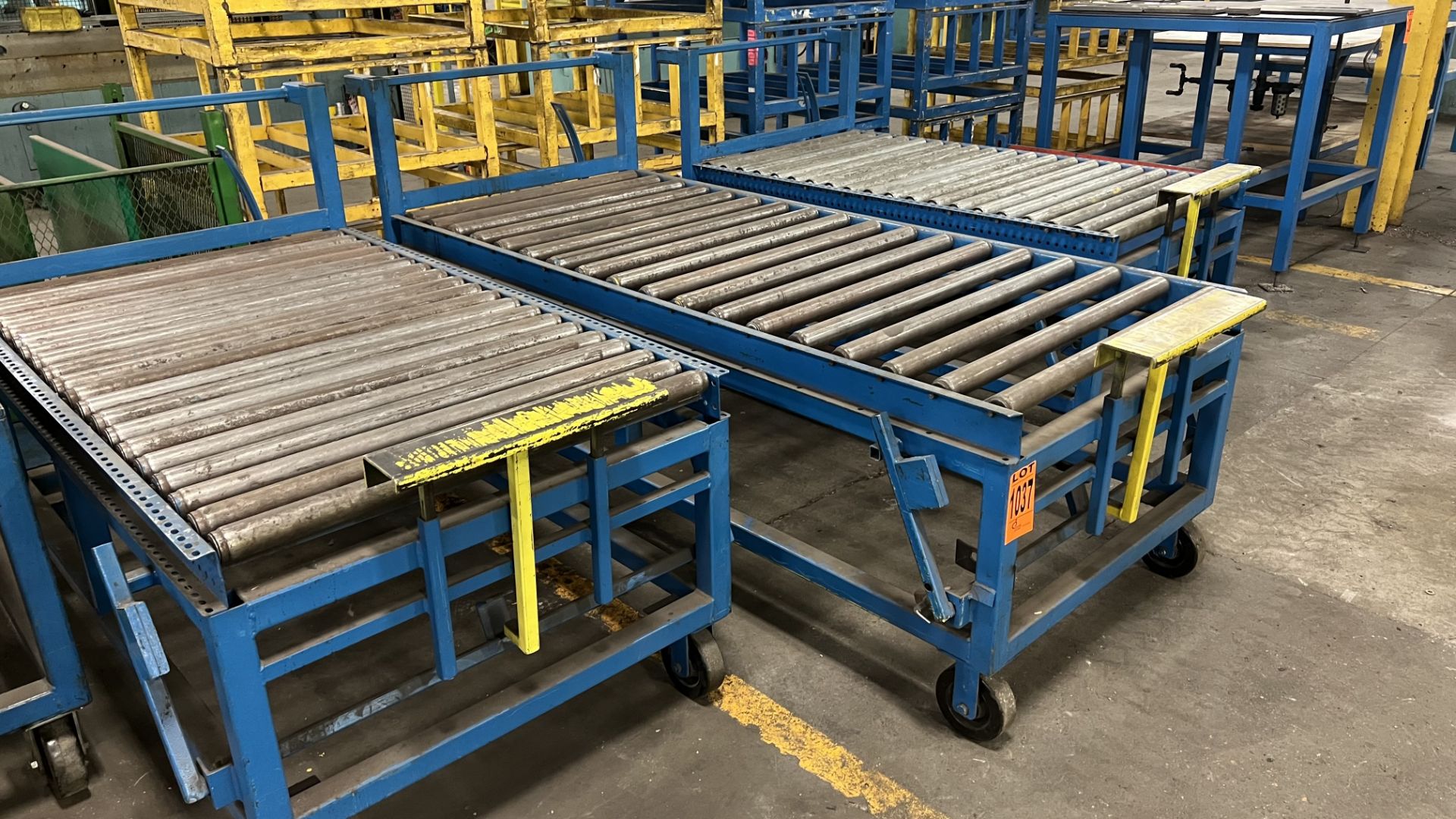 Lot of (3) mobile roller conveyors on casters w/ foot lock, adjustable bumper bars, handles