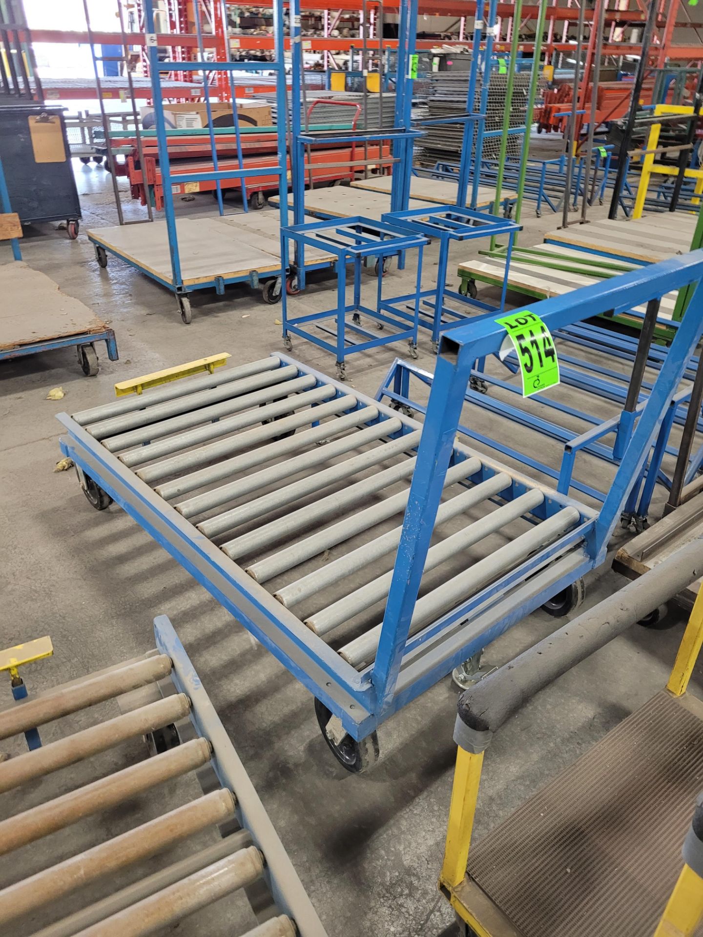 Heavy-duty steel roller conveyor on casters, w/ floor lock, handle, adjustable height backstop