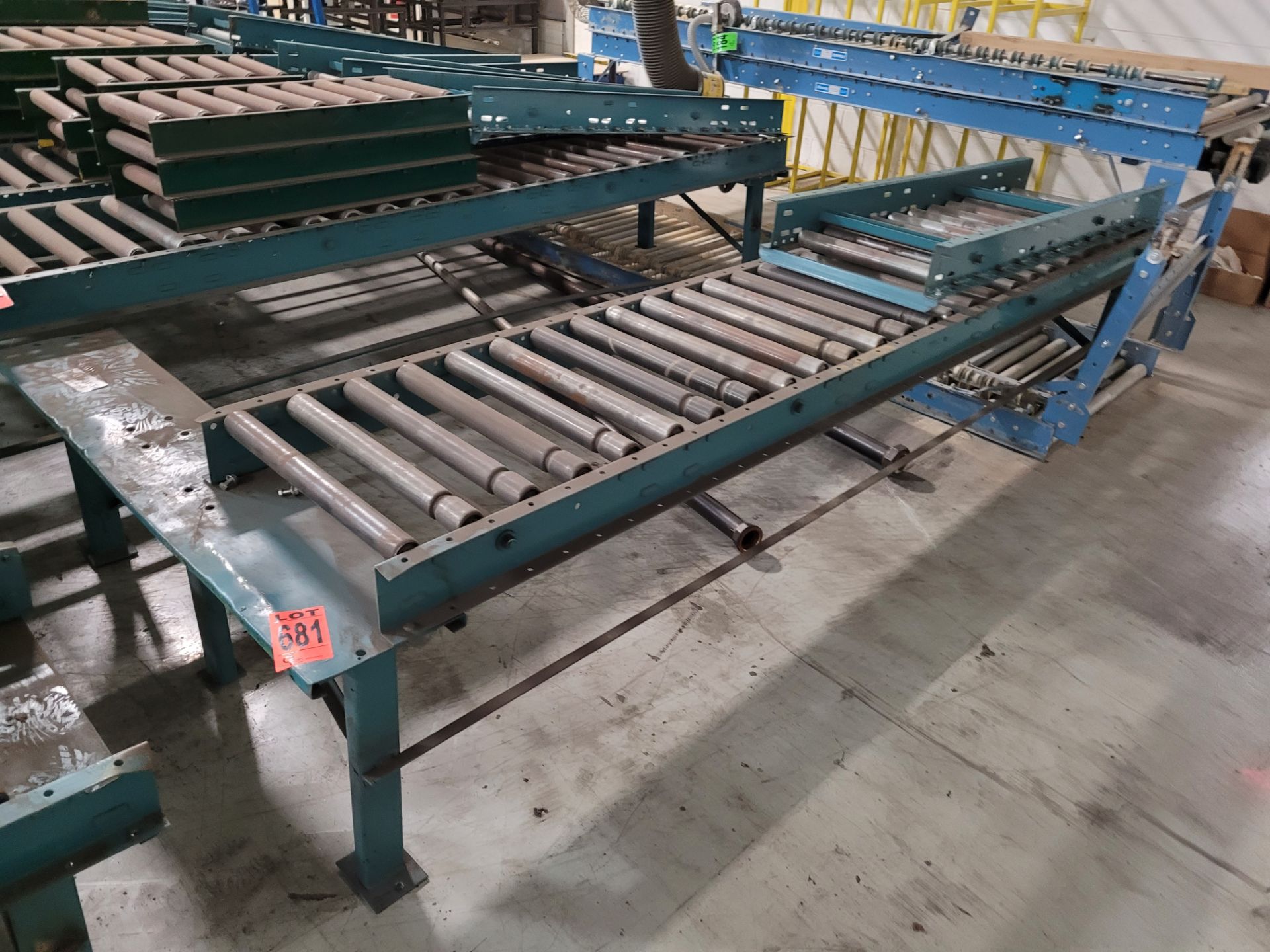 Section of double inclined manual roller conveyor w/ folding extension, 1' space between conveyors