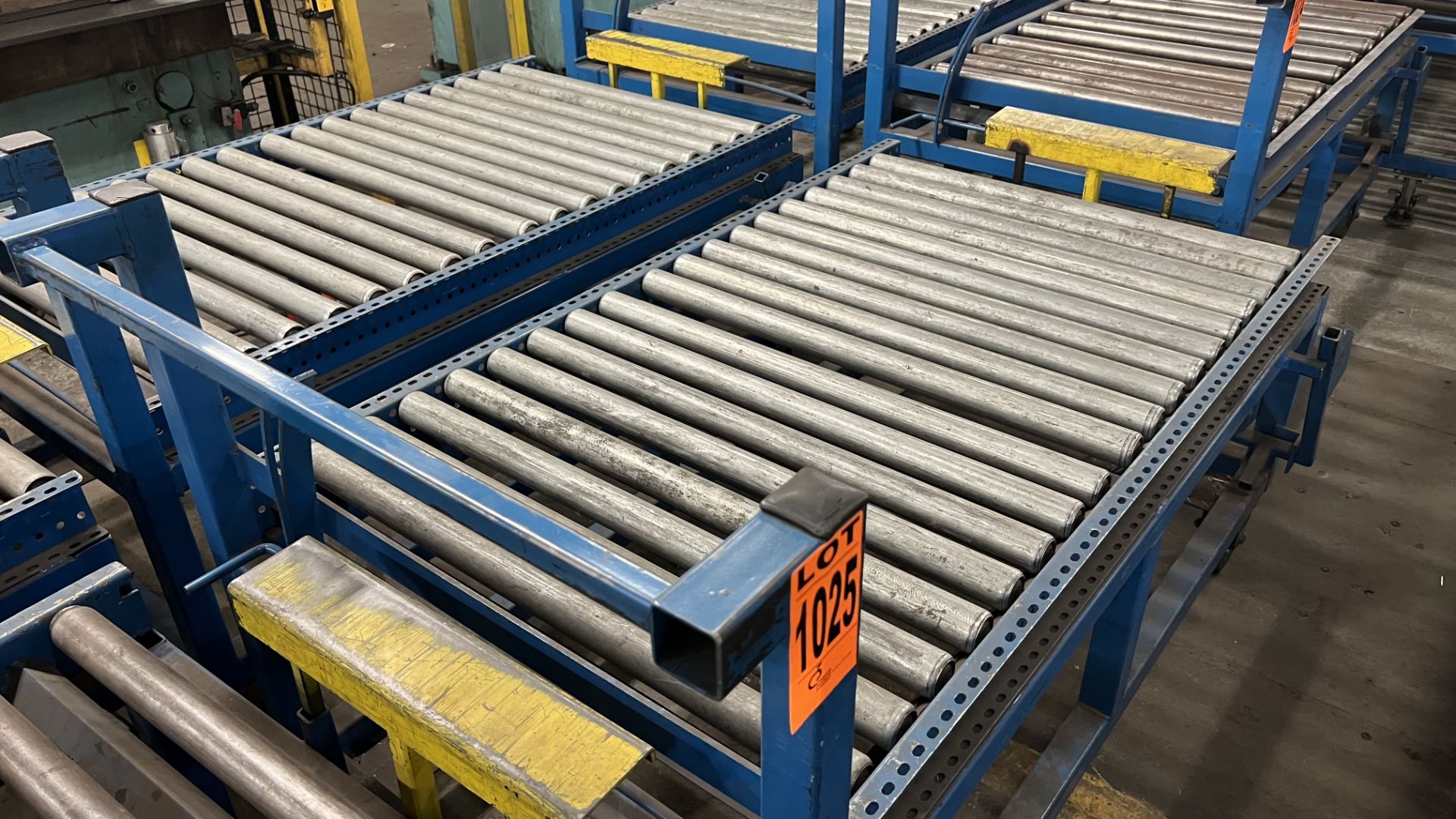 Lot of (2) steel frame manual roller conveyors w/ handles, casters, foot lock and adjustable height