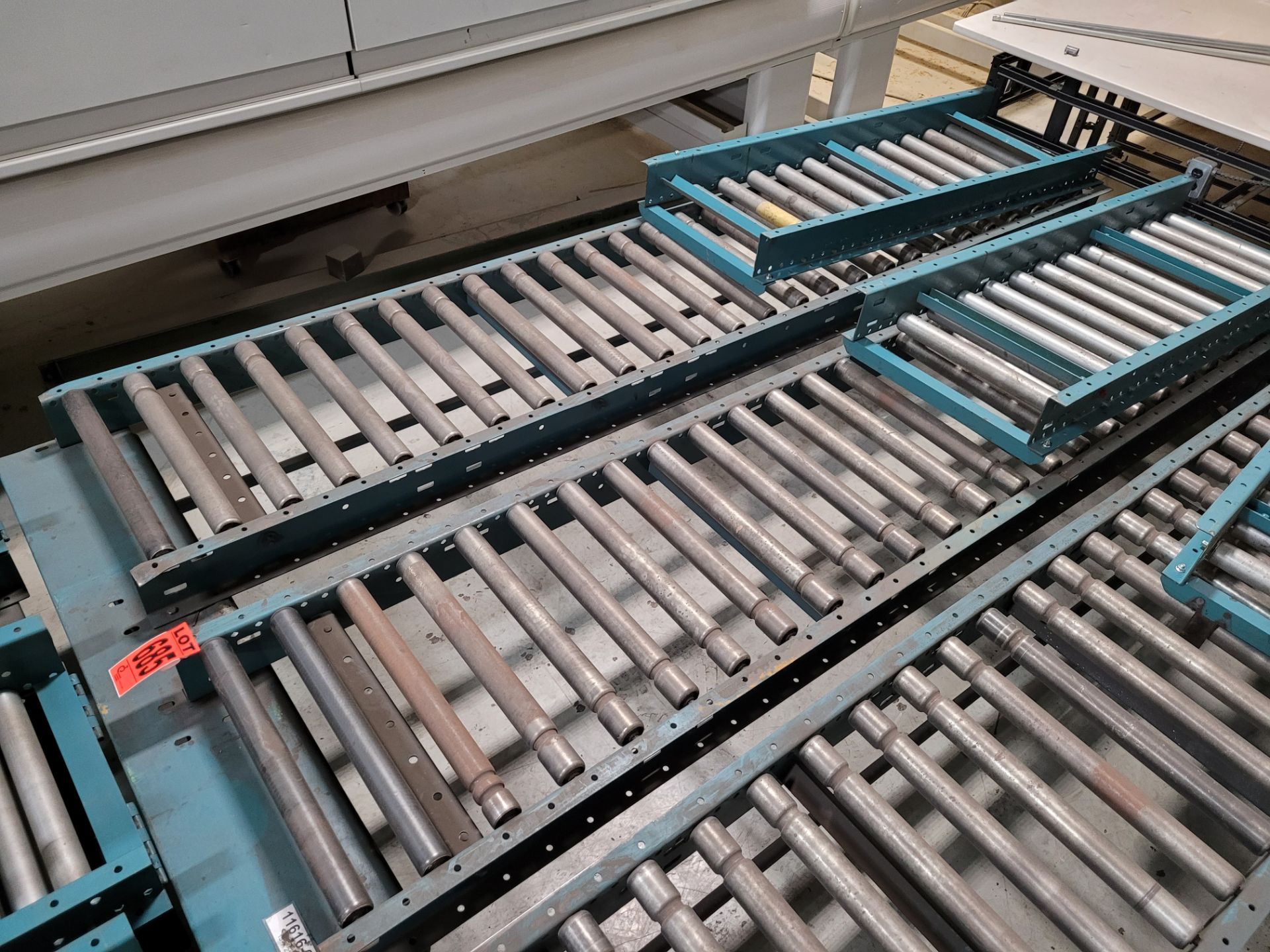 Section of double inclined manual roller conveyor w/ folding extension, 1' space between conveyors