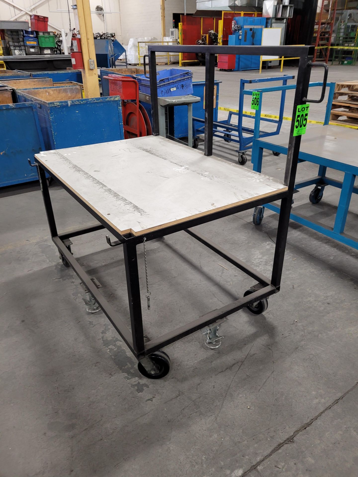 Mobile steel frame worktable with handle, on casters, w/ floor locks, plywood surface