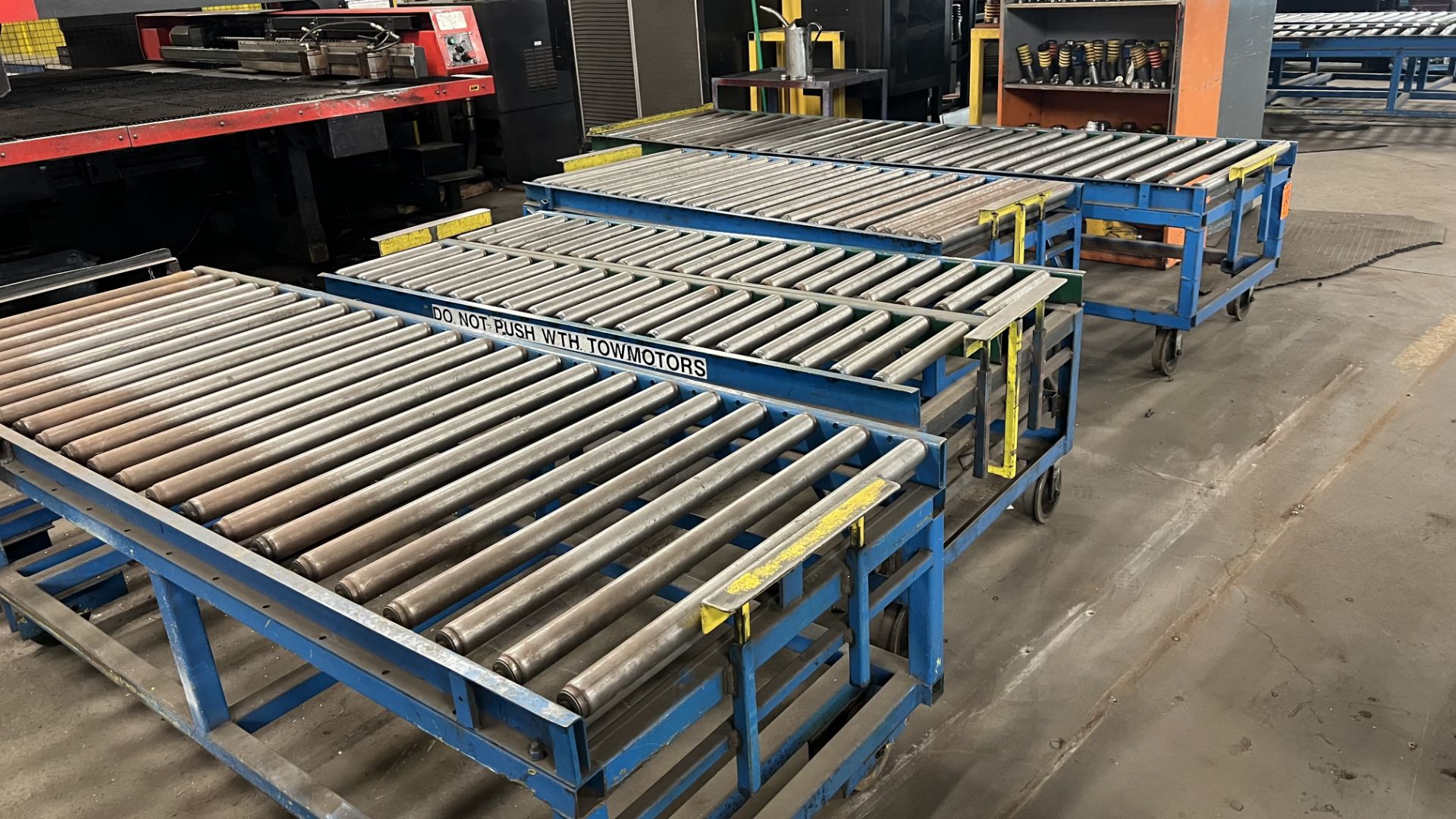 Lot of (4) sections of steel frame manual roller conveyors each w/ w-rail wheels and 2 casters, w/ a - Image 2 of 2