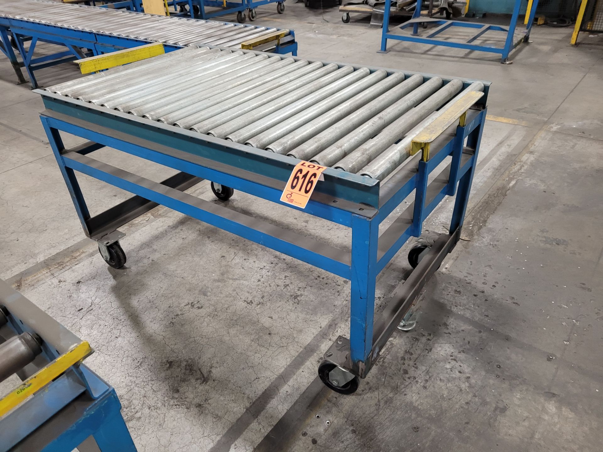 Mobile roller conveyor on casters w/floor lock and (2) adjustable steel backstops