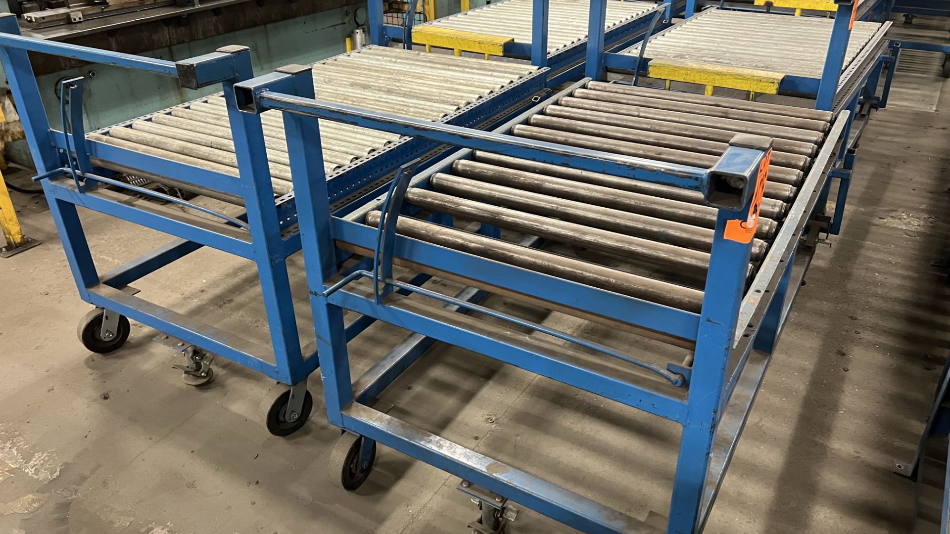 Lot of (3) steel frame manual roller conveyors w/ handles, casters, foot lock and adjustable height