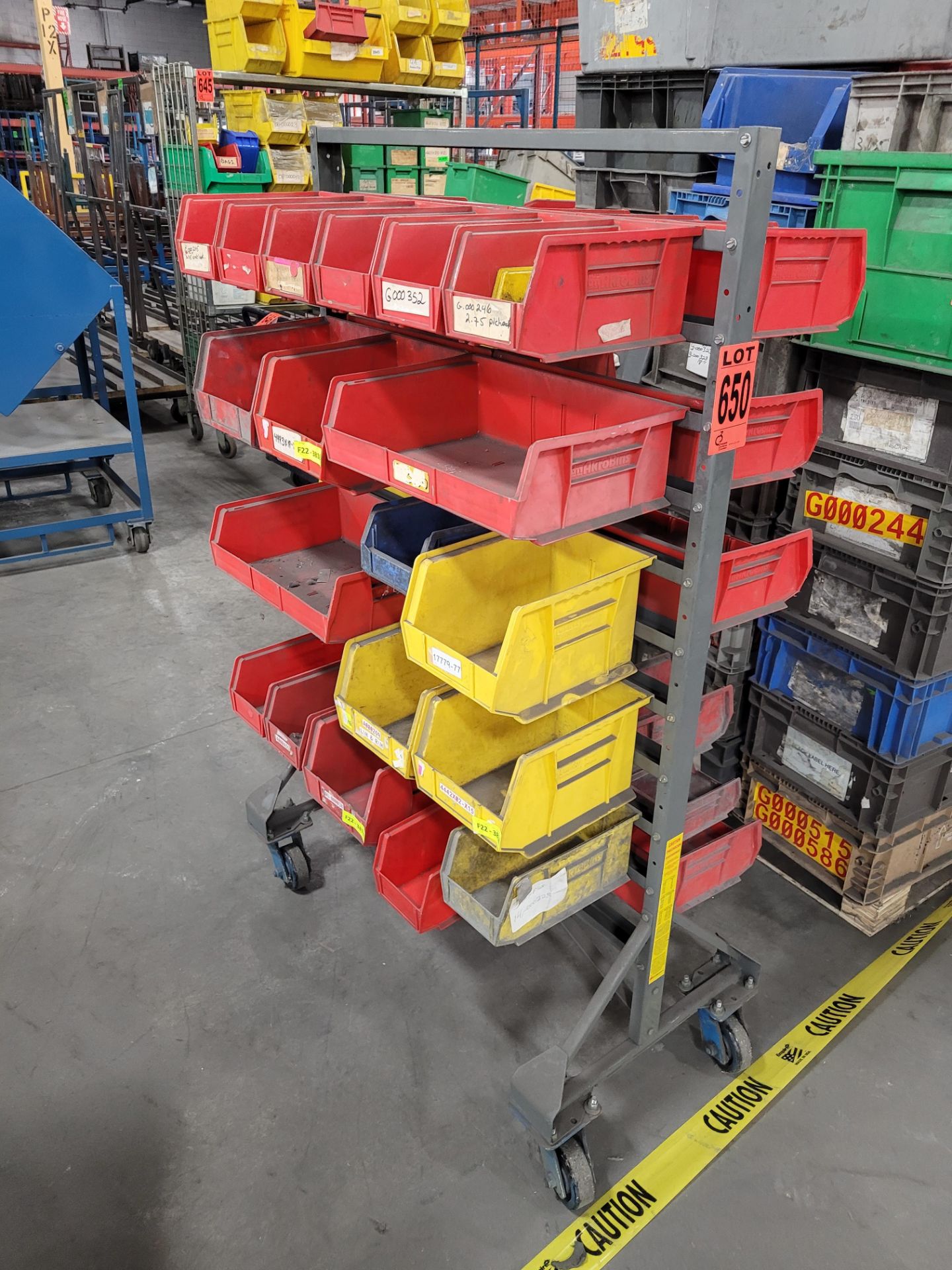 Steel mobile shelving unit w/ 36 plastic parts bins on locking casters