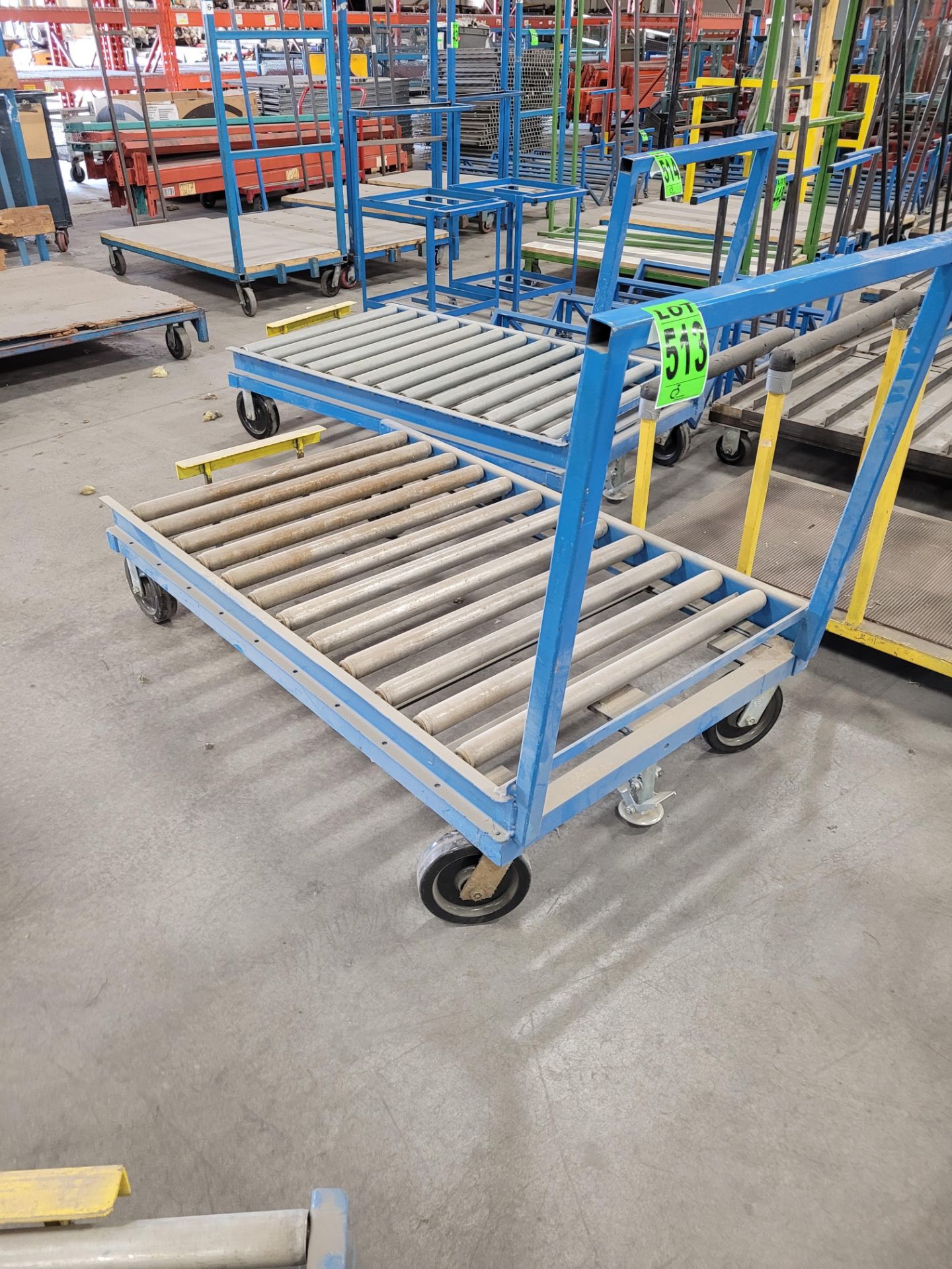 Heavy-duty steel roller conveyor on casters, w/ floor lock, handle, adjustable height backstop