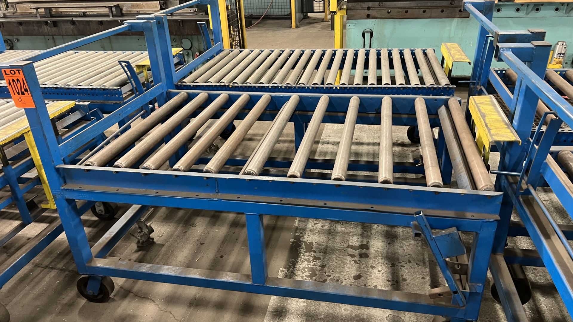 Lot of (2) steel frame manual roller conveyors w/ handles, casters, foot lock and adjustable height