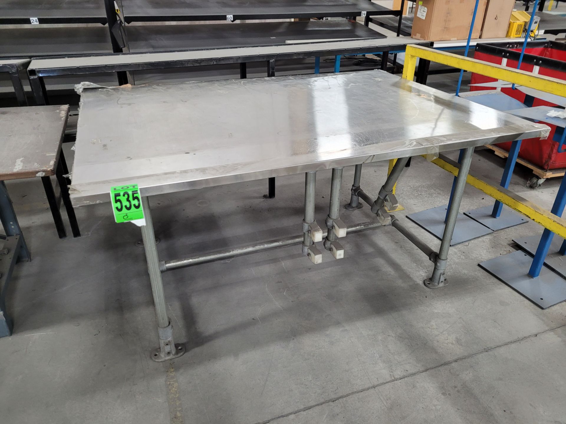 Stainless steel worksurface on steel frame w/ composite piece holders