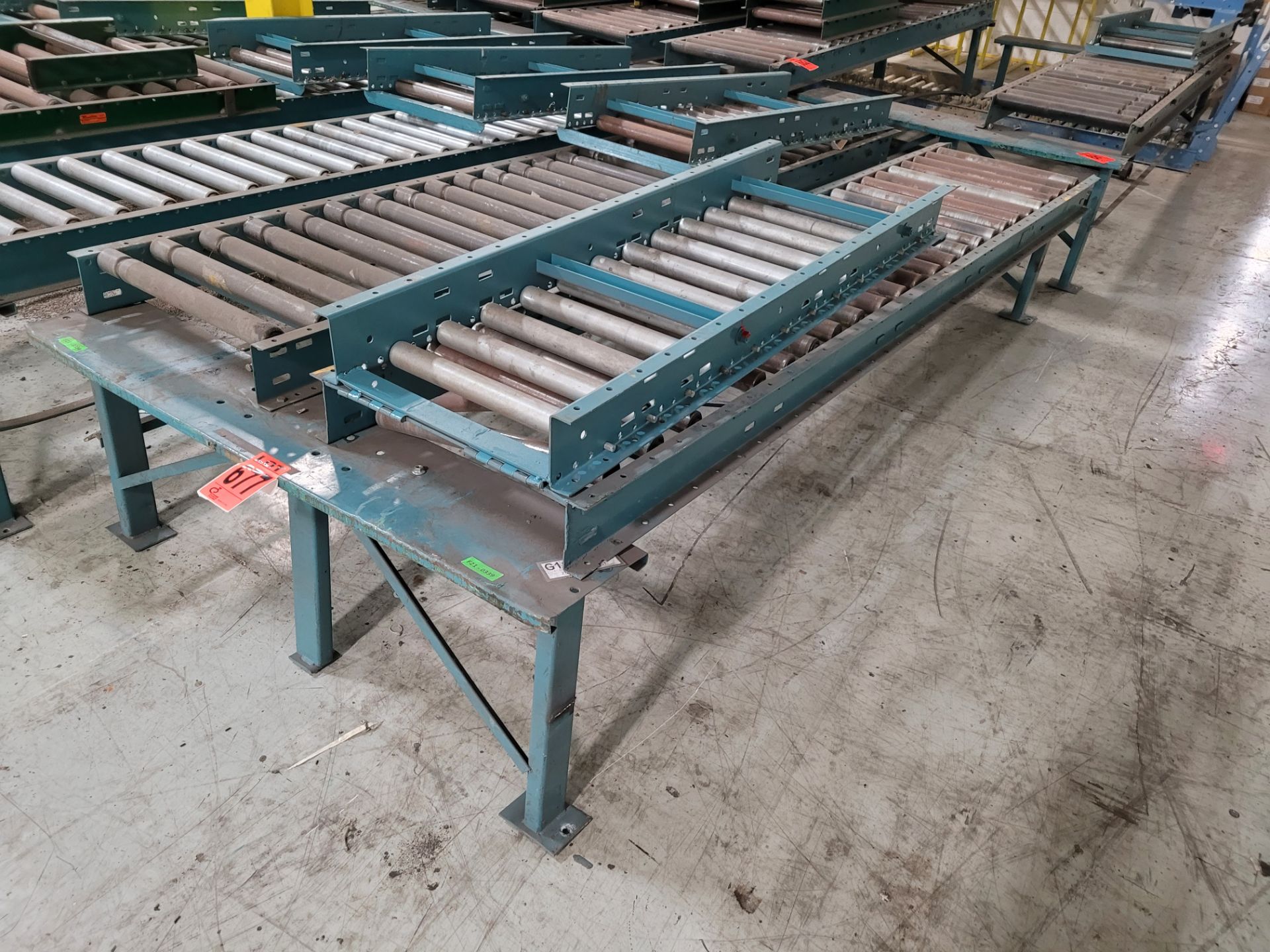 Section of double inclined manual roller conveyor w/ folding extension, 1' space between conveyors