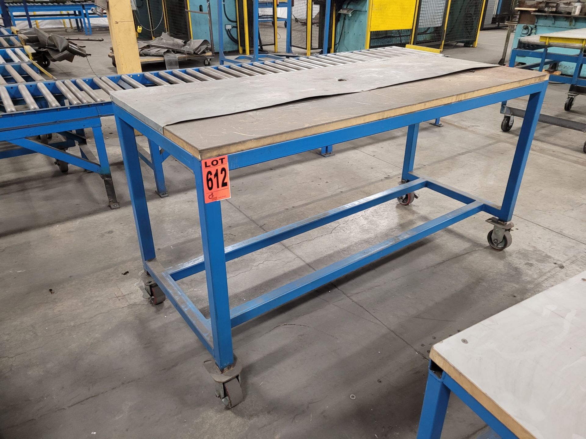 Mobile steel frame worktable on lockable casters w/plywood surface