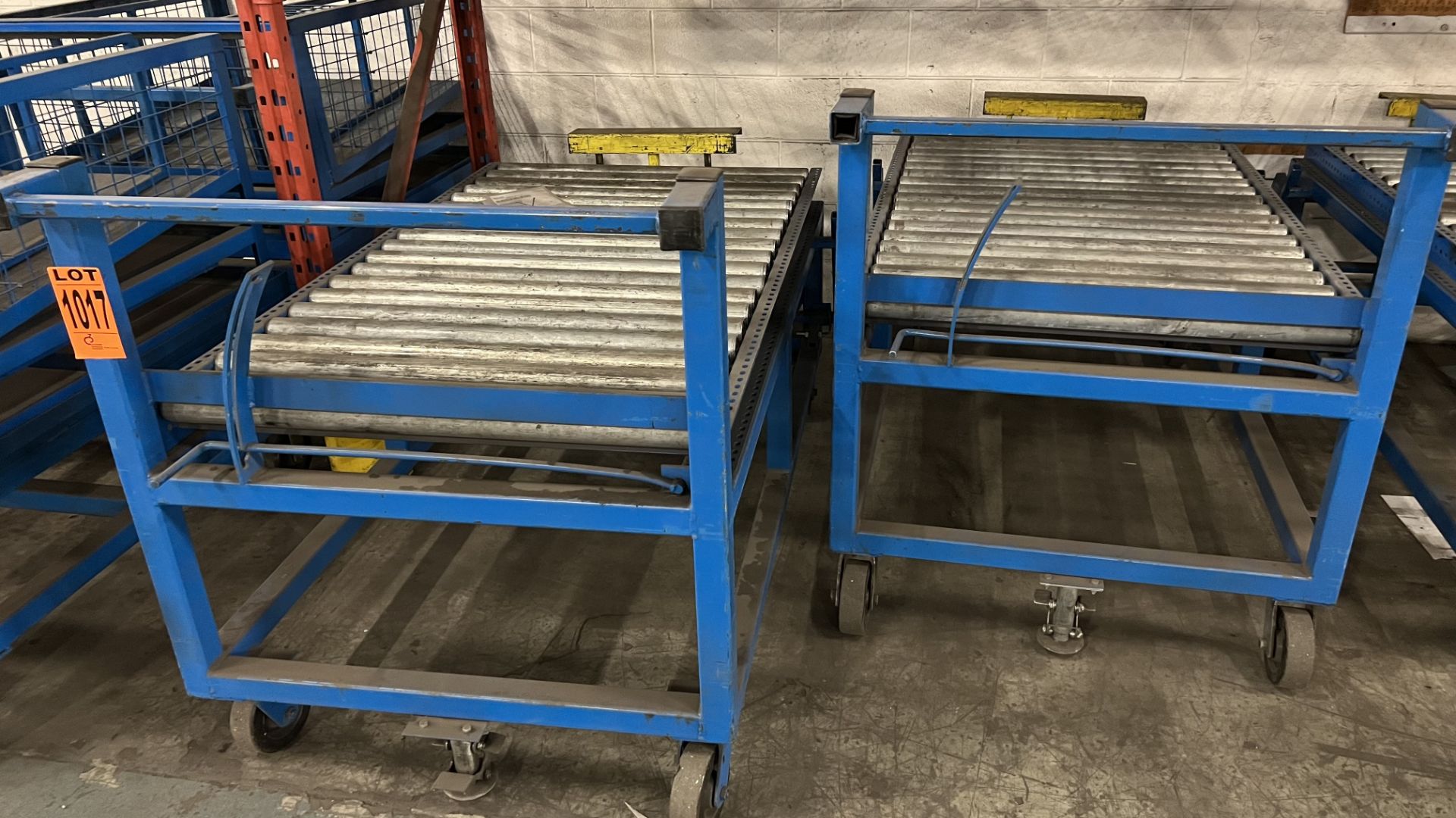 Lot of (2) steel frame manual roller conveyors w/ handles, casters, foot lock and adjustable height
