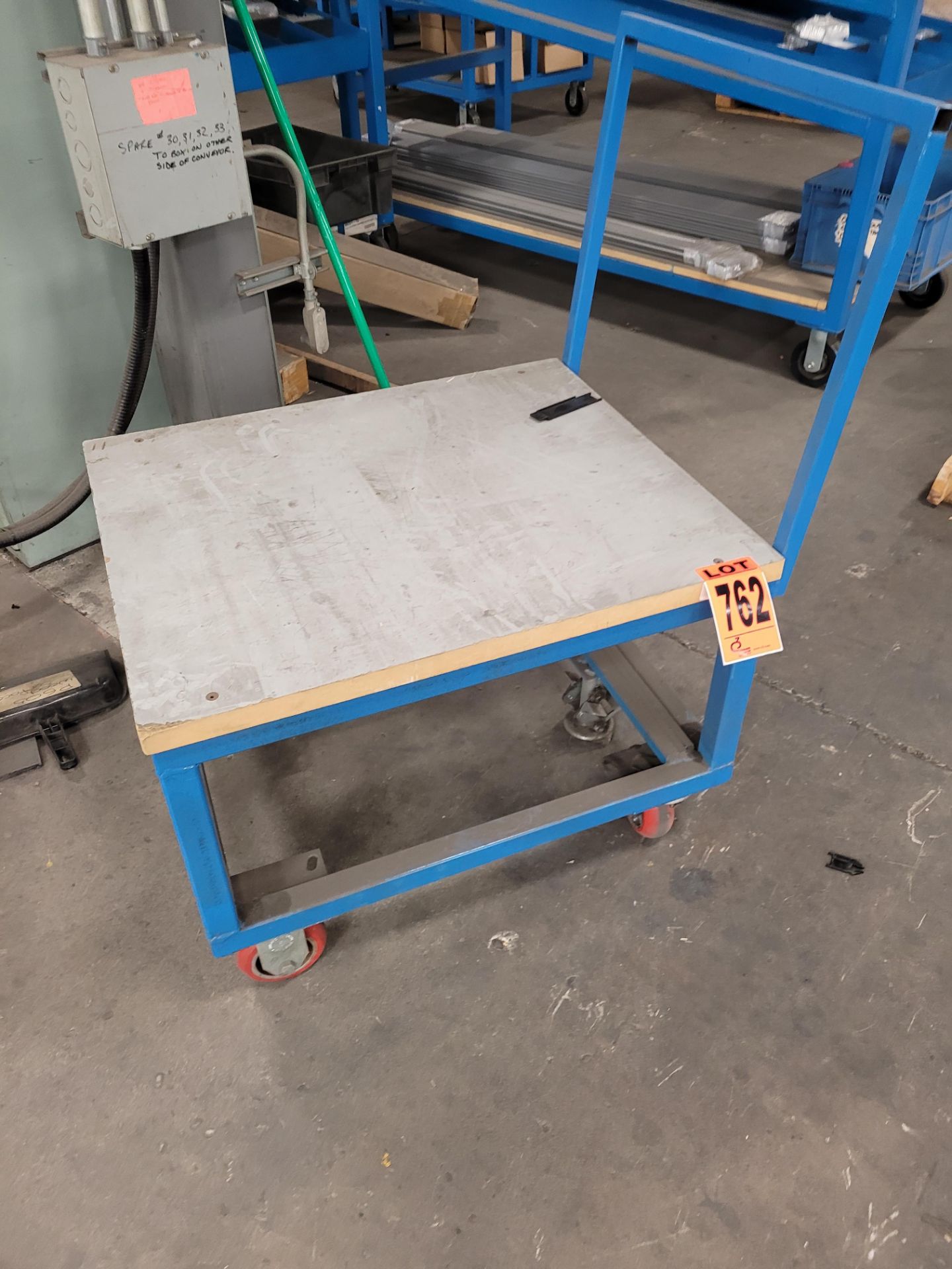 Steel frame platform cart w/ casters, floor lock, handle and plywood surface
