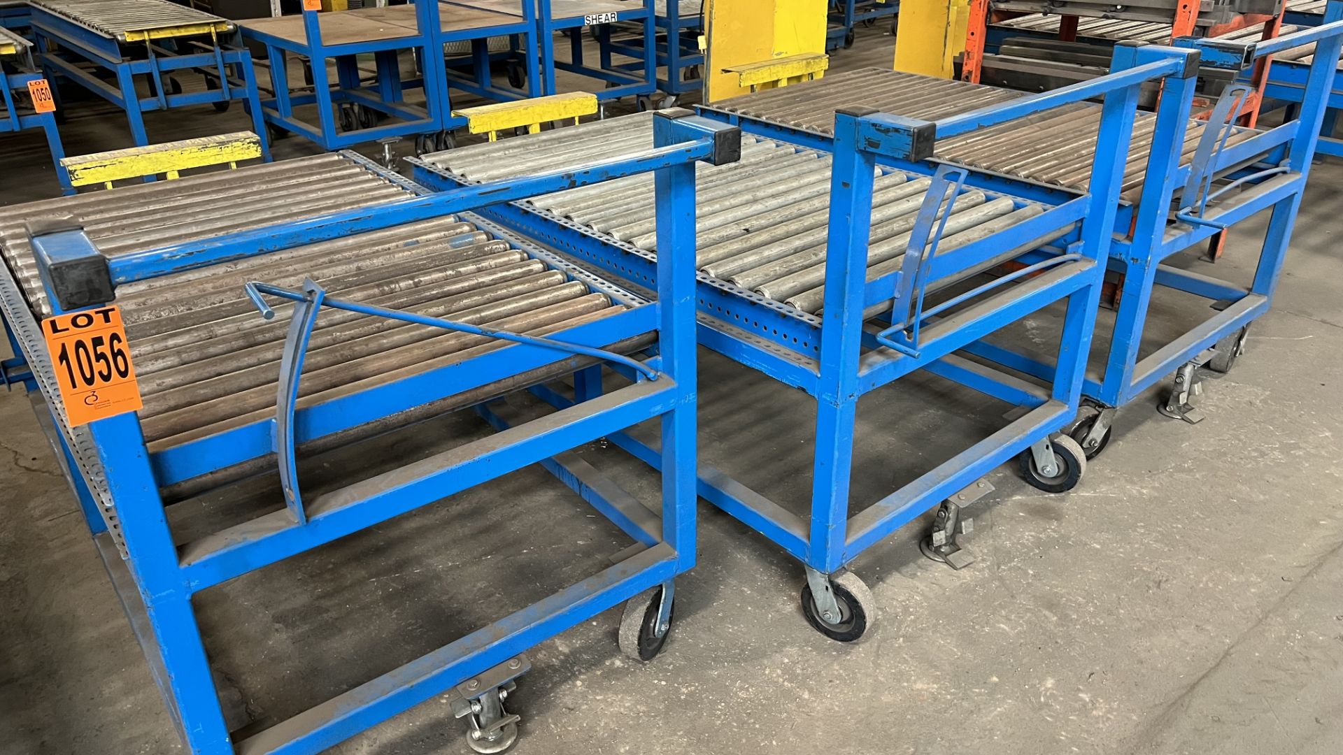 Lot of (3) steel frame manual roller conveyors w/ handles, casters, foot lock and adjustable height