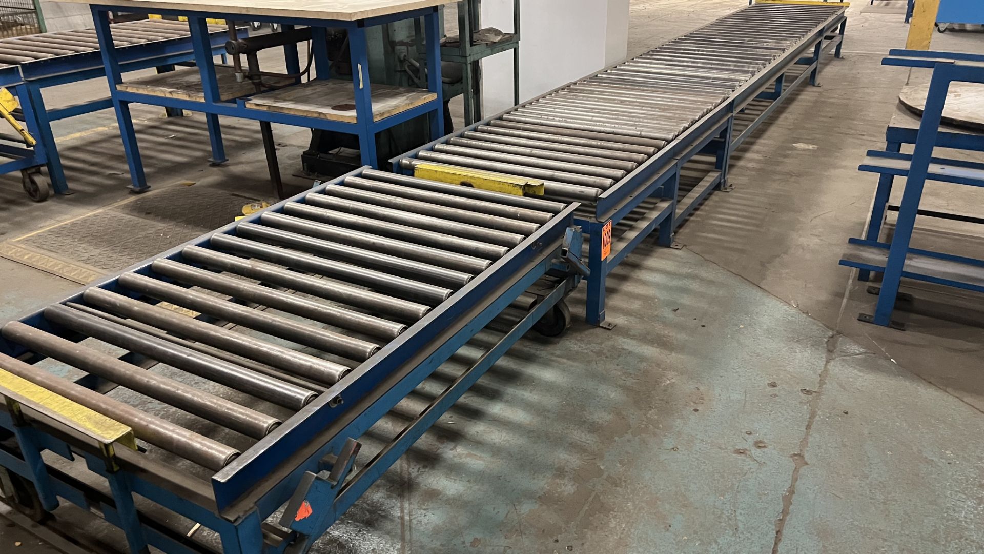 Lot of (3) sections of steel frame manual roller conveyor incl. (1) mobile unit on steel rail wheels