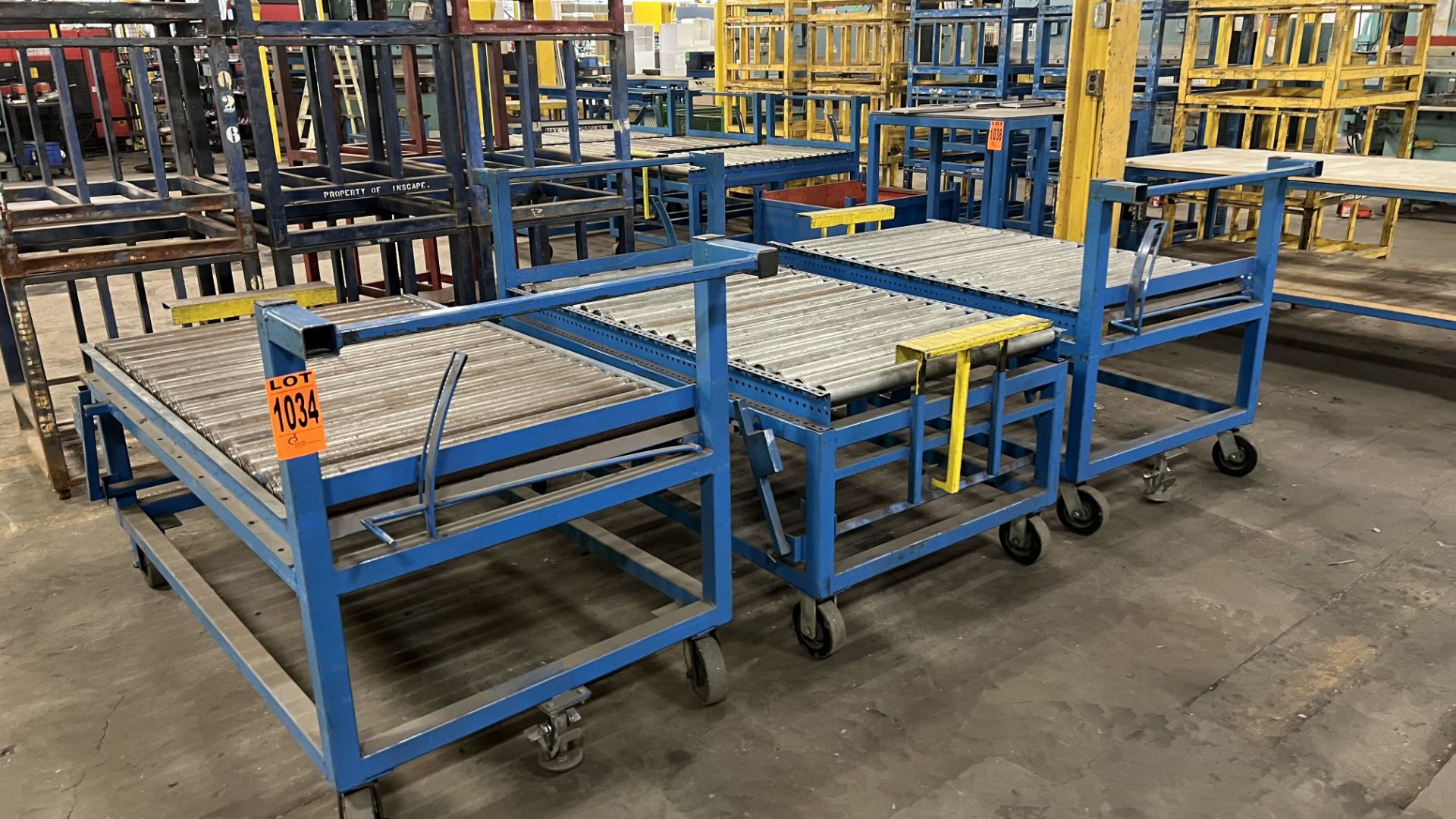 Lot of (3) mobile roller conveyors on casters w/ foot lock, adjustable bumper bars, handles