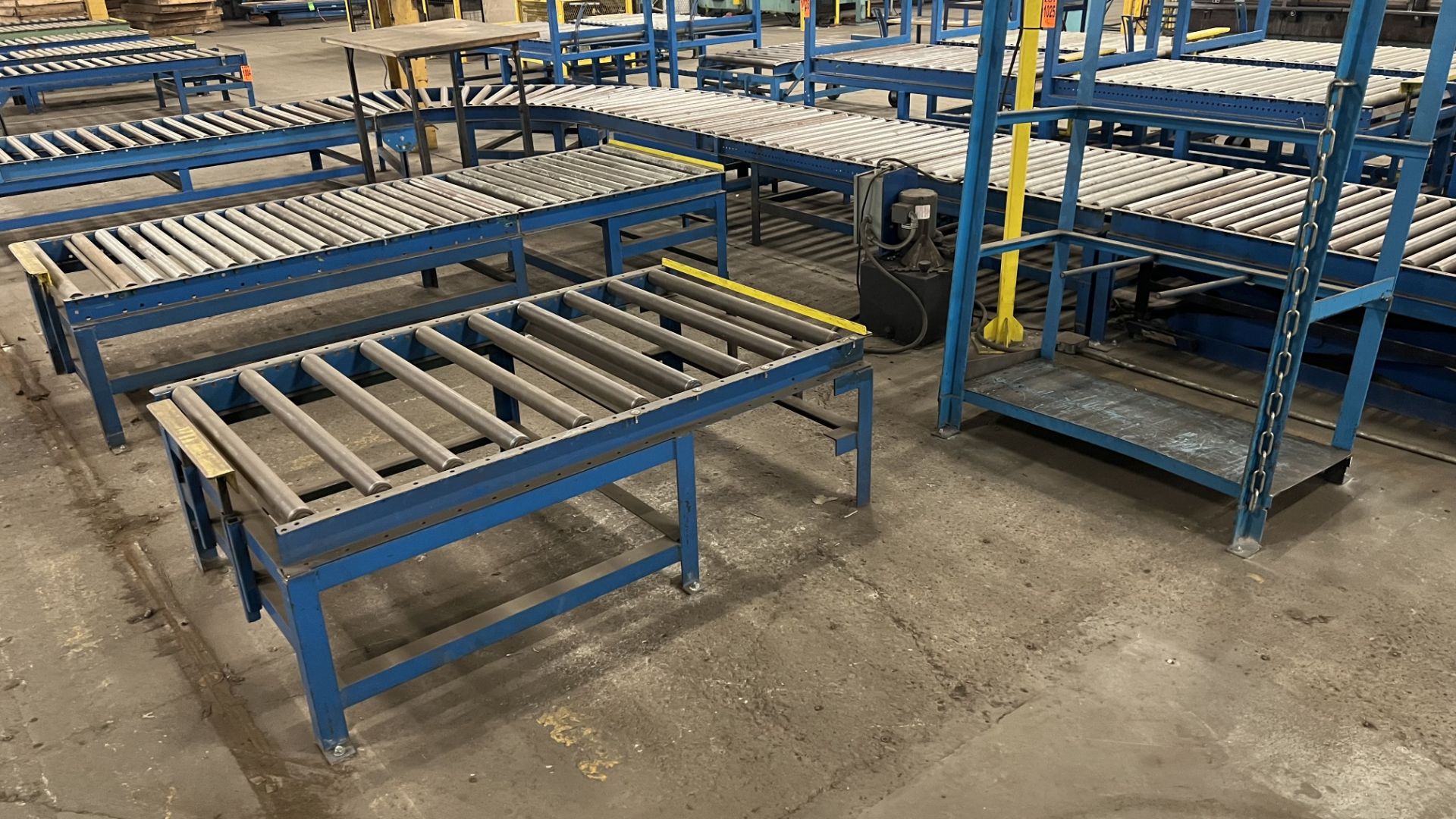 Lot of (2) steel frame manual roller conveyors w/ handles, casters, foot lock and adjustable height