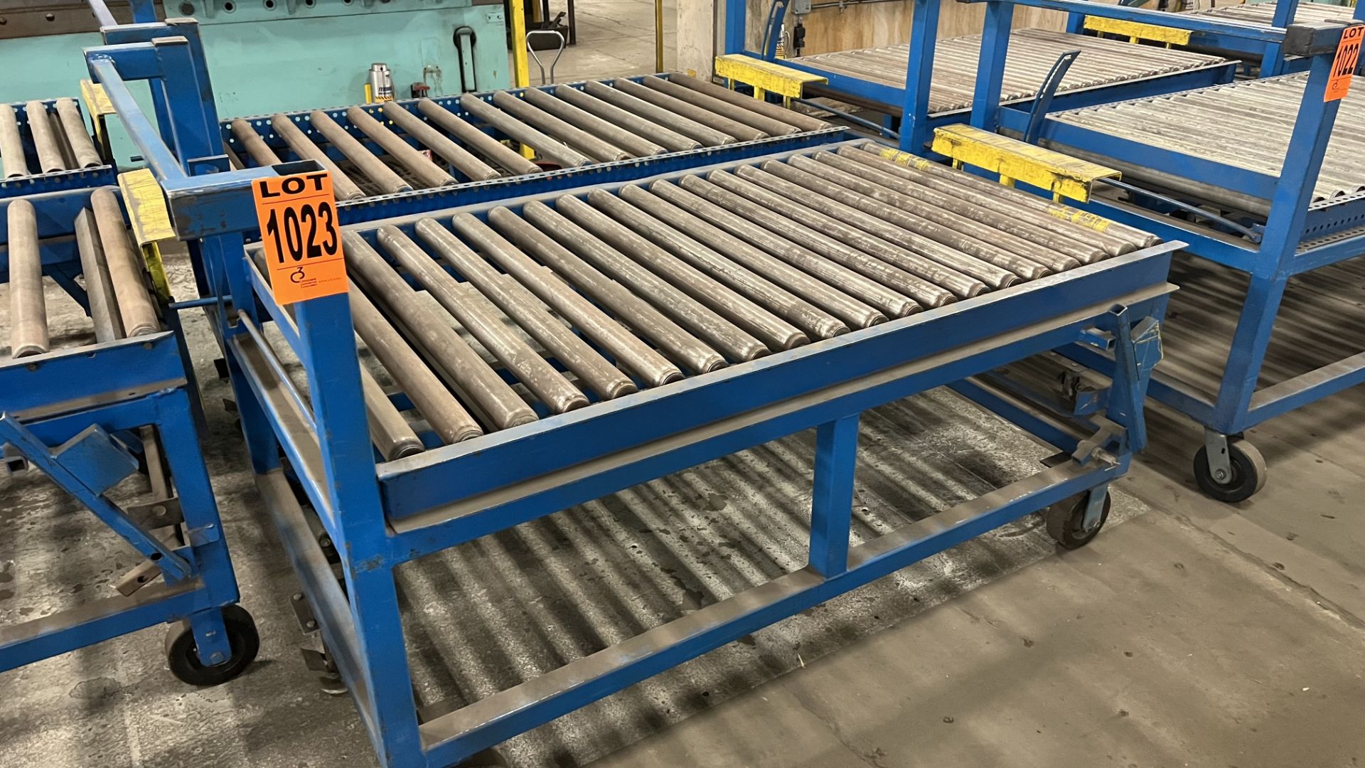 Lot of (2) steel frame manual roller conveyors w/ handles, casters, foot lock and adjustable height