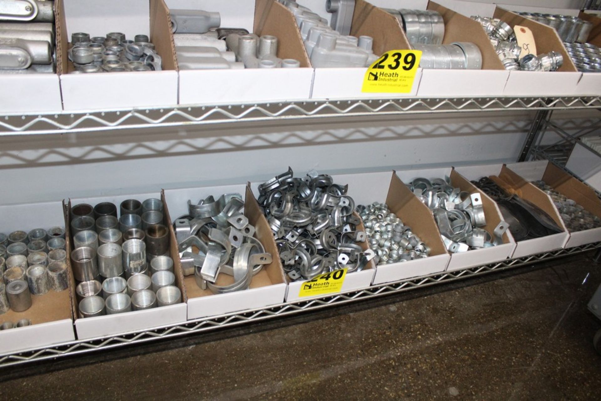 ASSORTED CONDUIT HANGERS AND THREADED FITTINGS ON SHELF