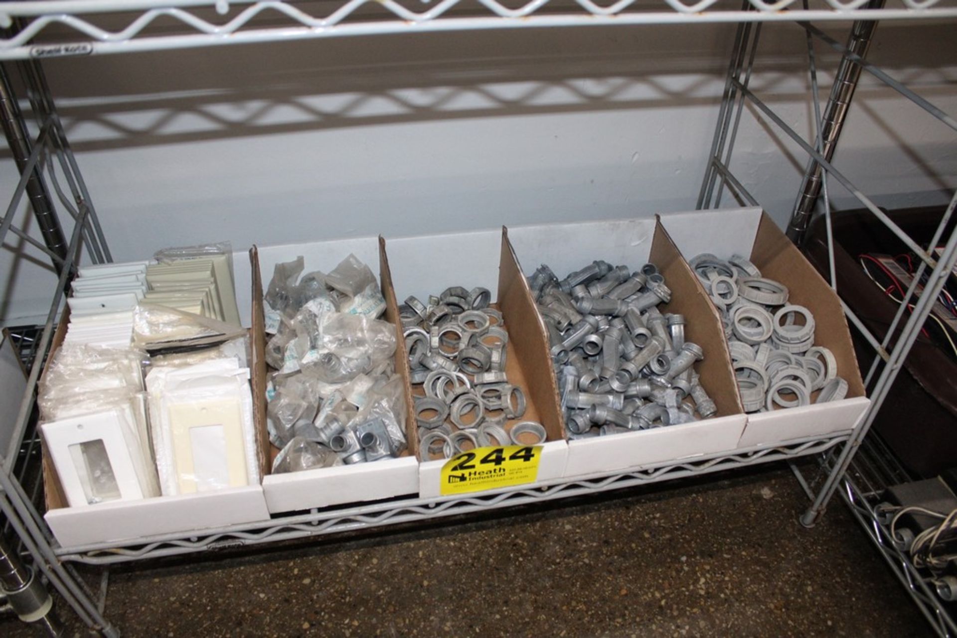 ASSORTED SWITCH COVERS AND CONDUIT FITTINGS ON SHELF