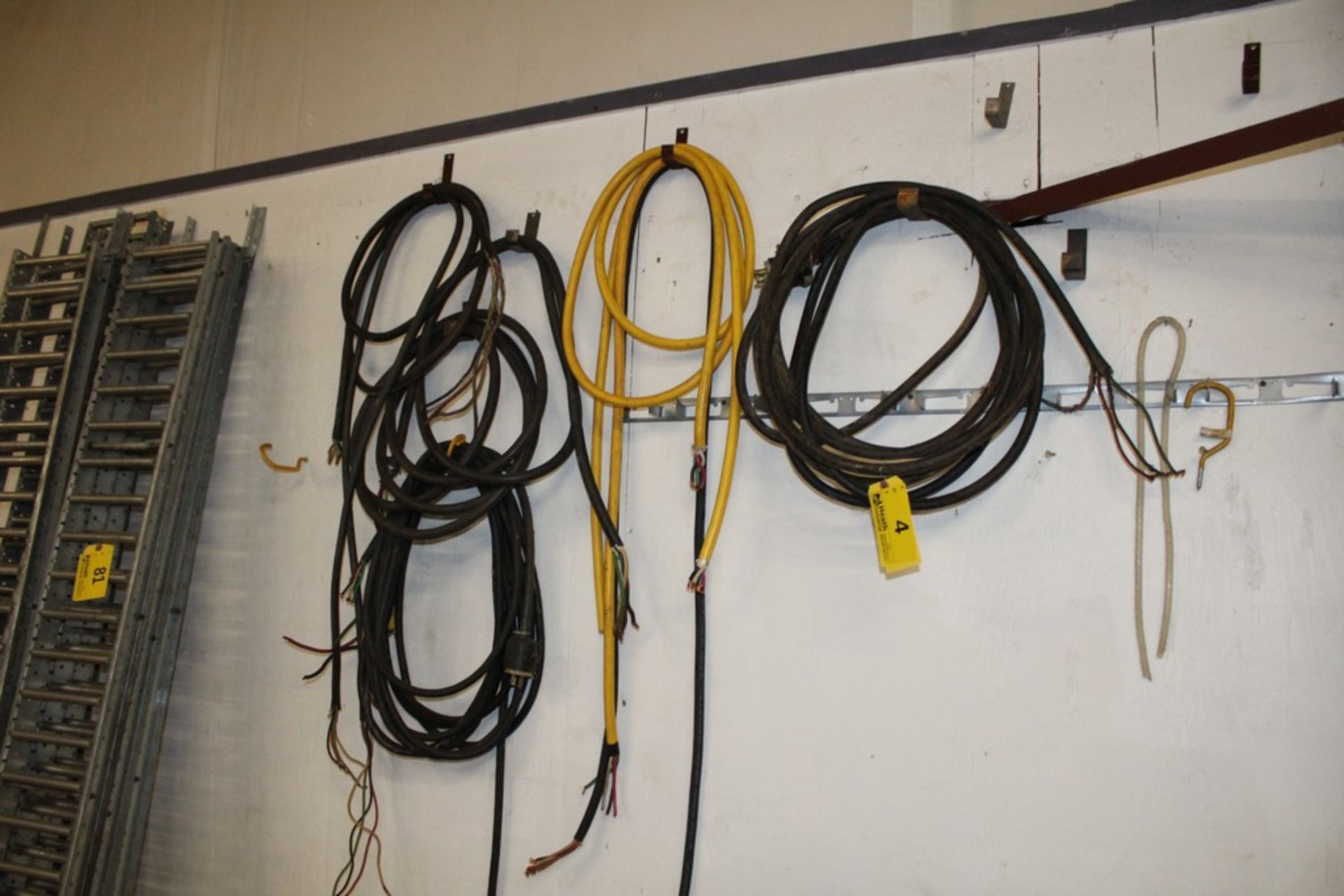 ASSORTED ELECTRICAL CORDS ON WALL